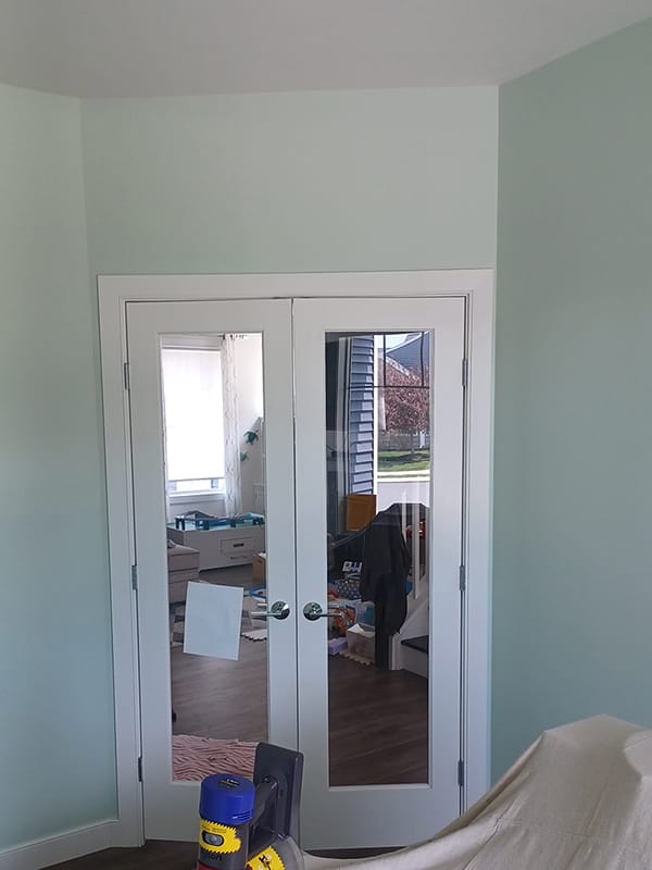 Light green after painting walls with white trim and glass doors