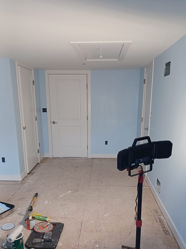 Freshly painted basement room with light blue walls