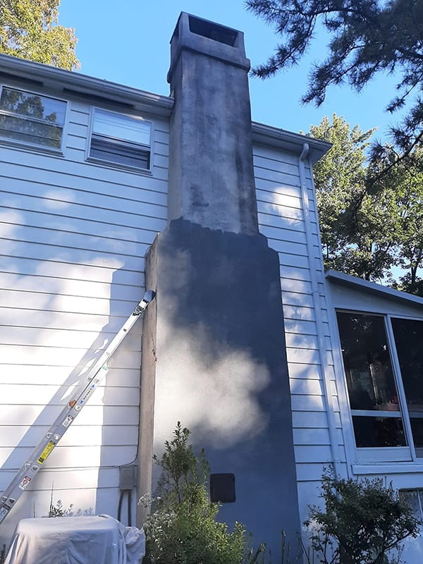 Home exterior before painting with light siding and dark trim