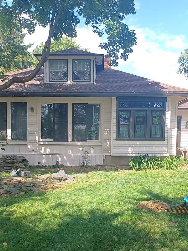 Craftsman style home exterior with off-white siding before paint job