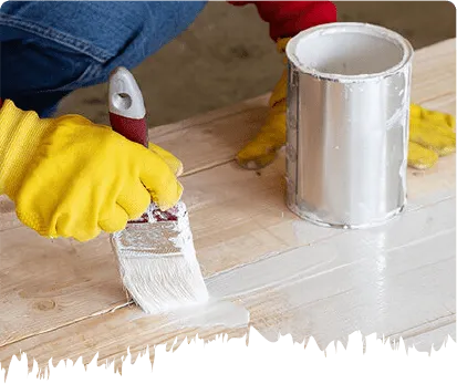 Applying white primer to a wooden deck before painting