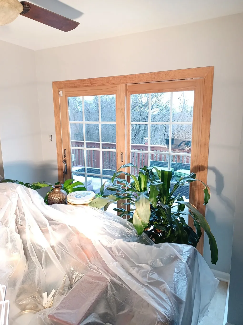 Room prepared for painting with furniture covered in plastic