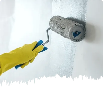 Paint roller applying white paint to interior wall surface